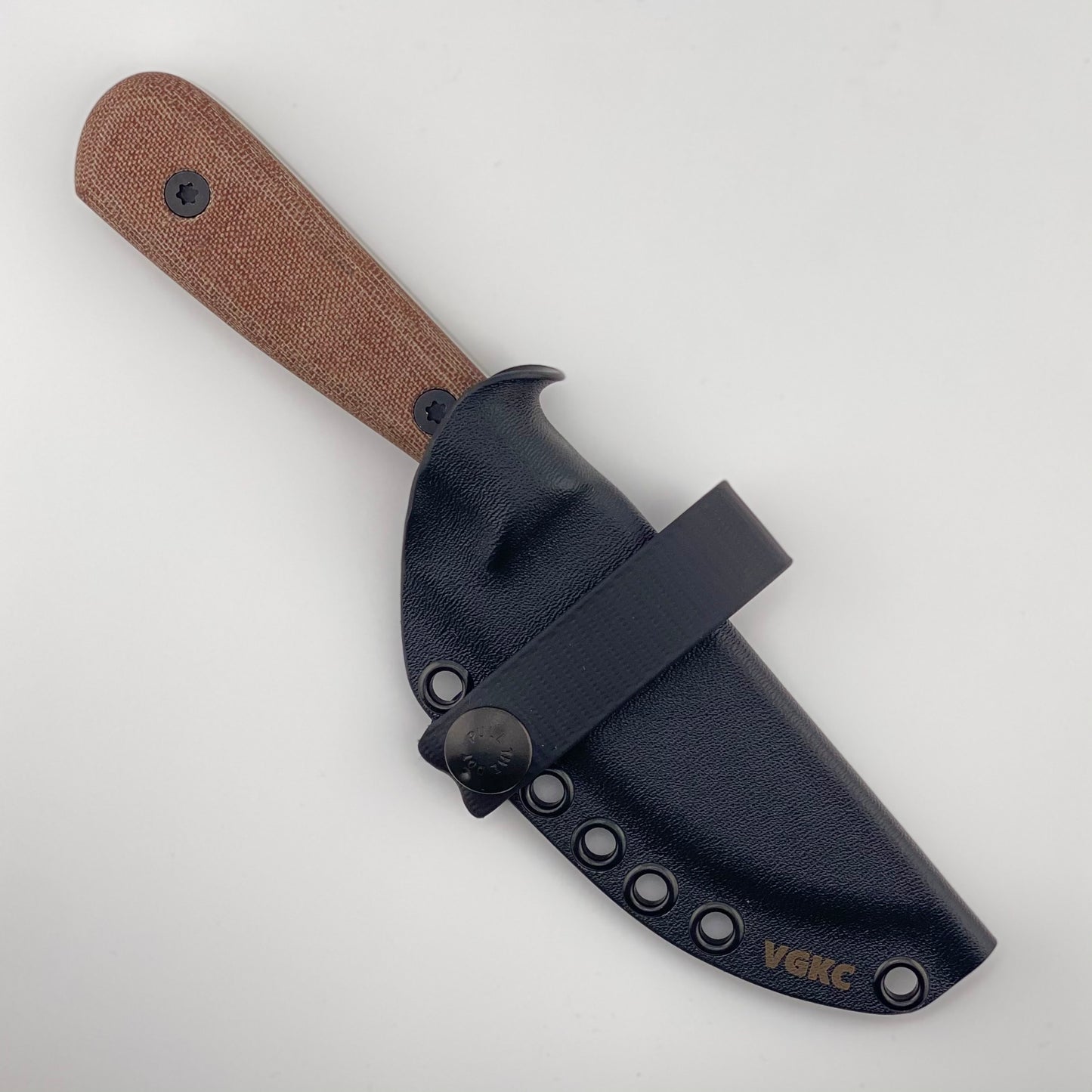 Knife with brown handle and black sheath on a light gray background
