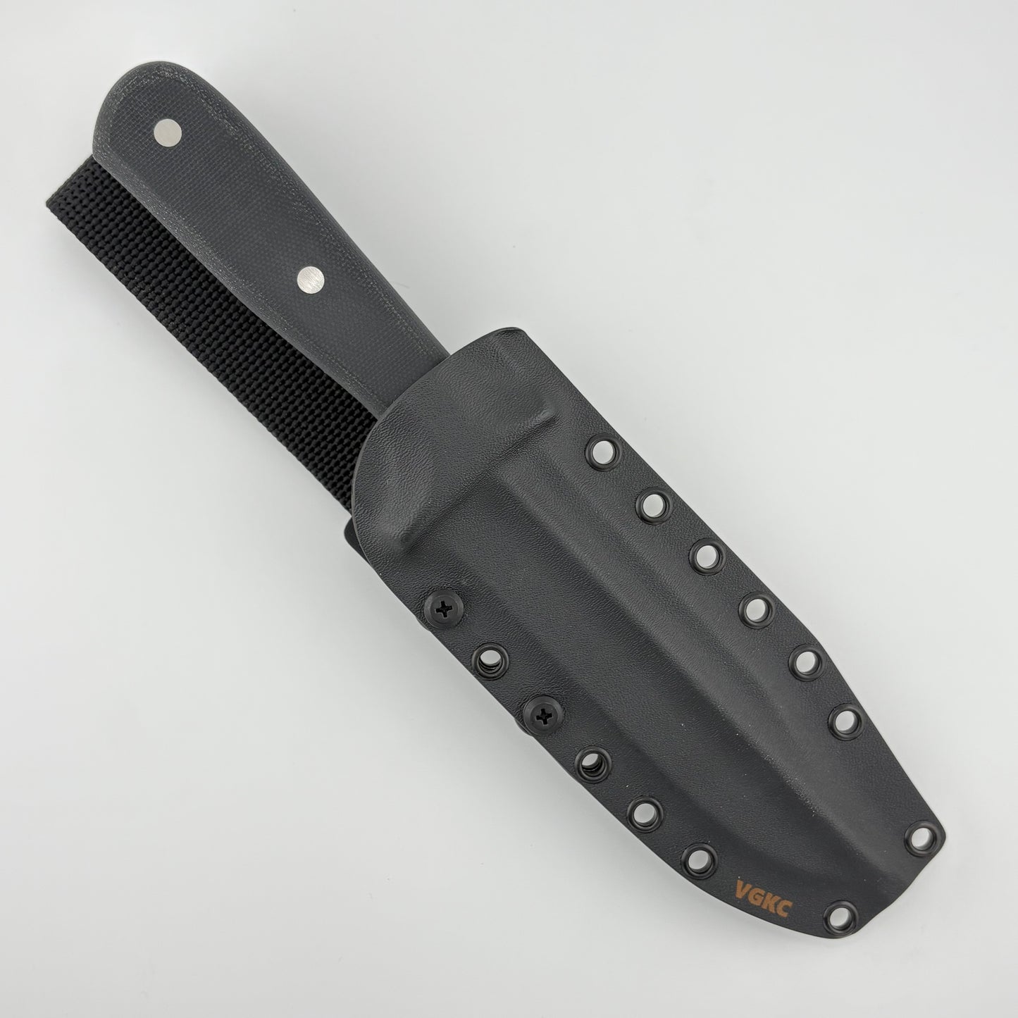 Black handled knife in a black sheath on a white background