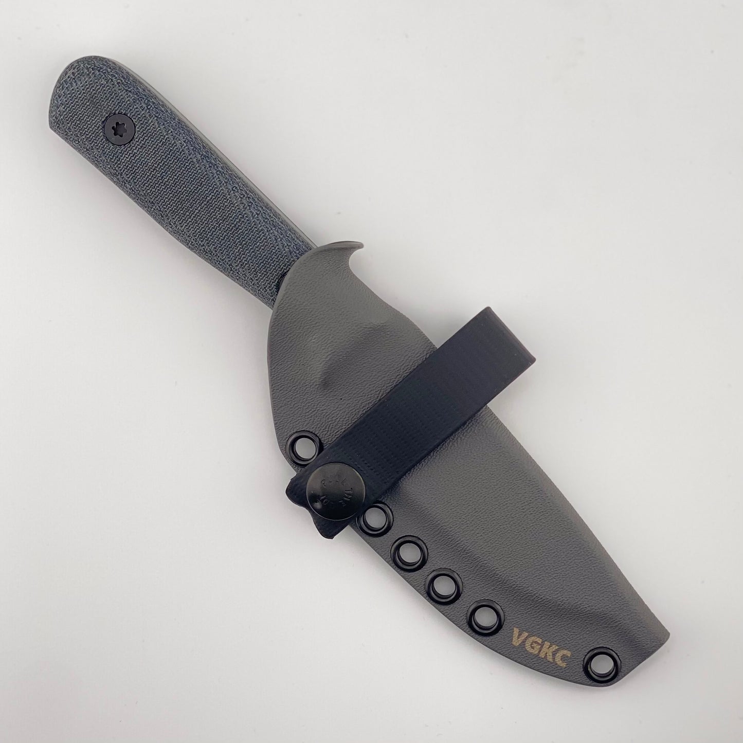 Gray fixed blade knife with denim blue handles in a gray sheath with a black strap on a white background