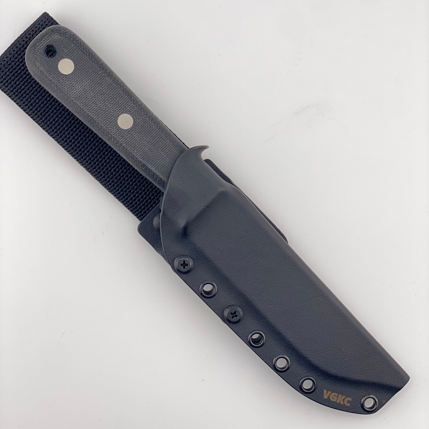 Fixed blade knife with a black handle in a black sheath on a white background
