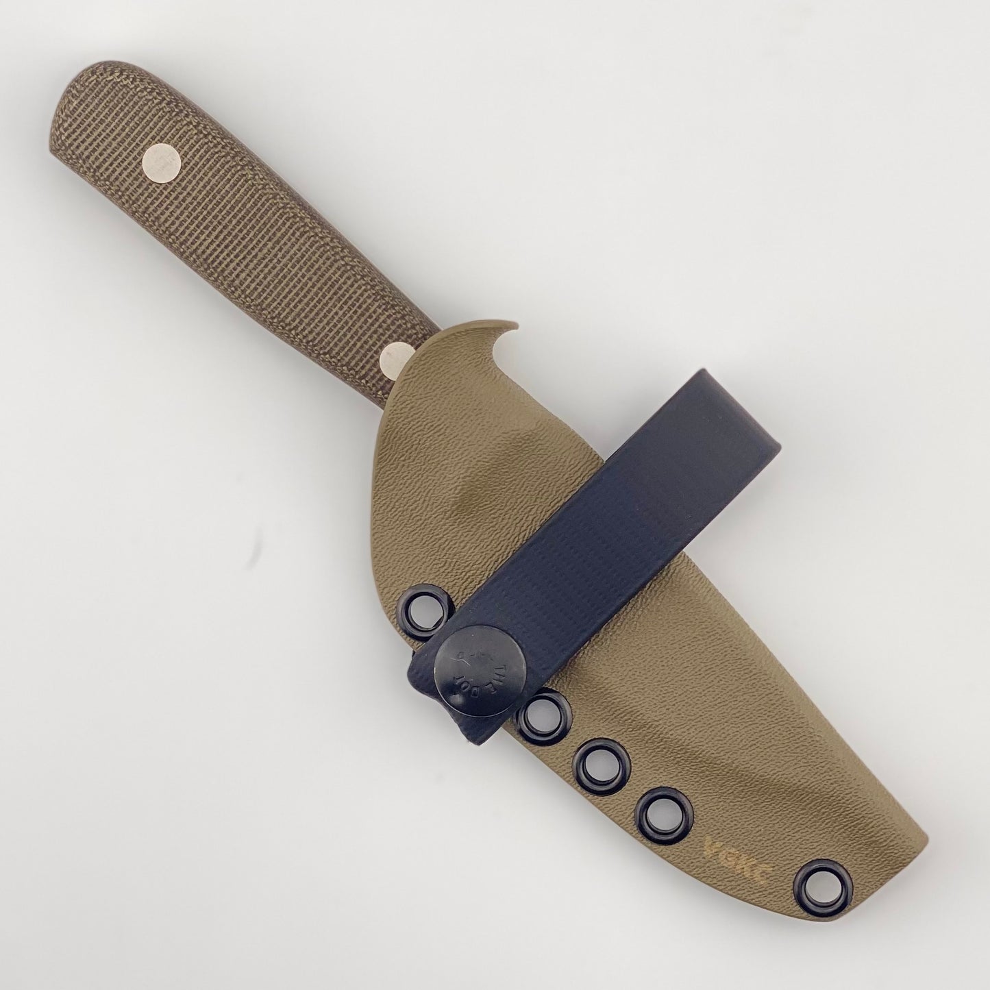Fixed blade knife with dark green handles in a tan sheath with a black strap on a white background