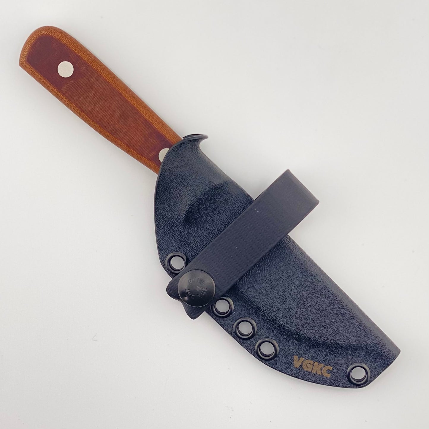 Knife with a brown handle and black sheath on a white background