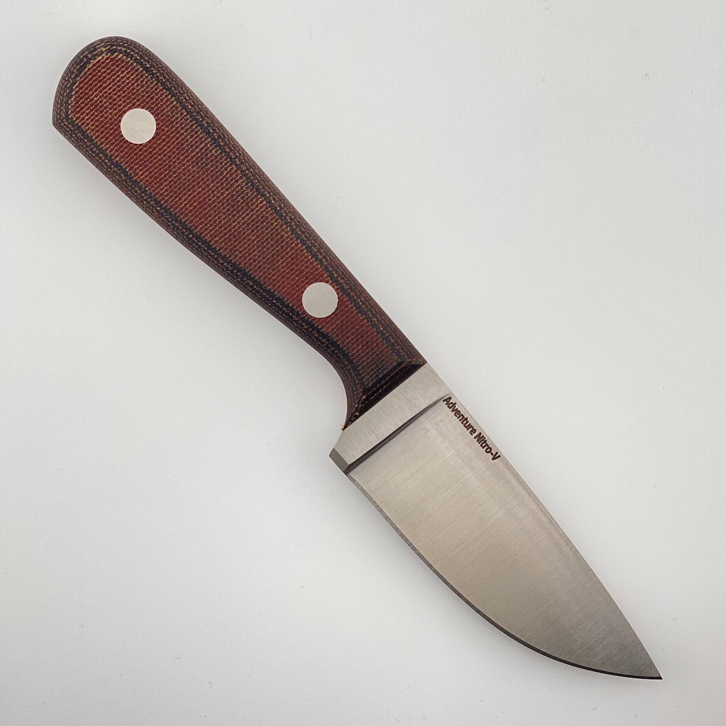 Knife with an orange and black handle on a white background