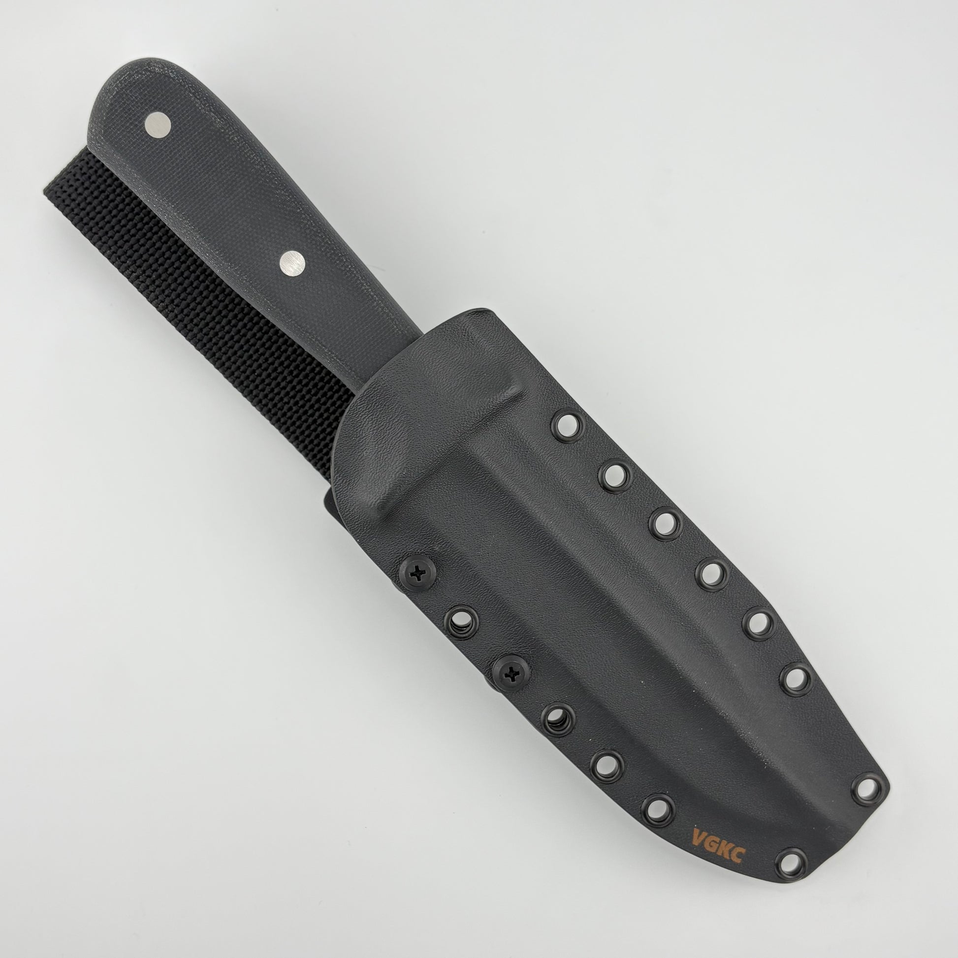 Black handled knife in a black sheath on a white background