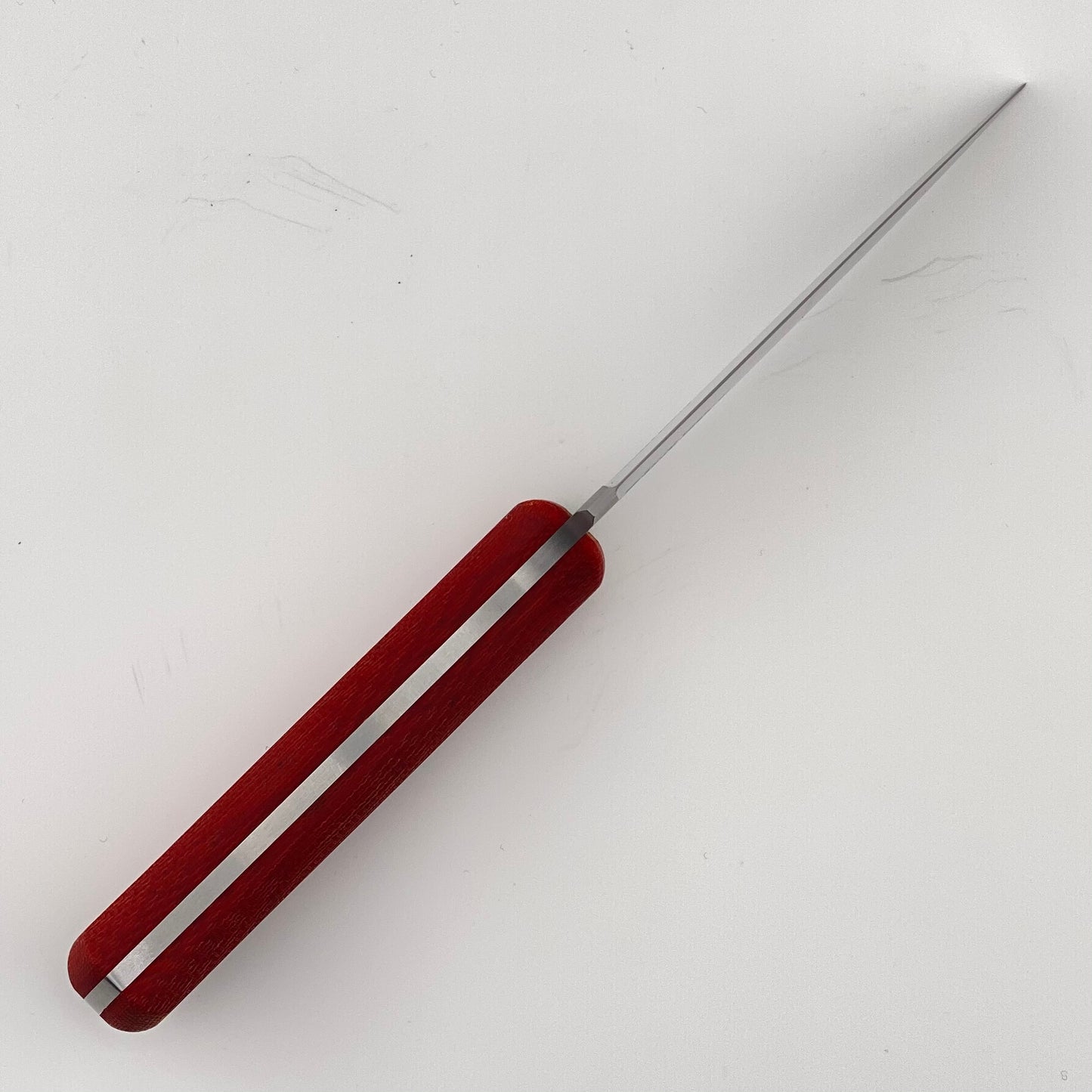 Red-handled knife on a white background