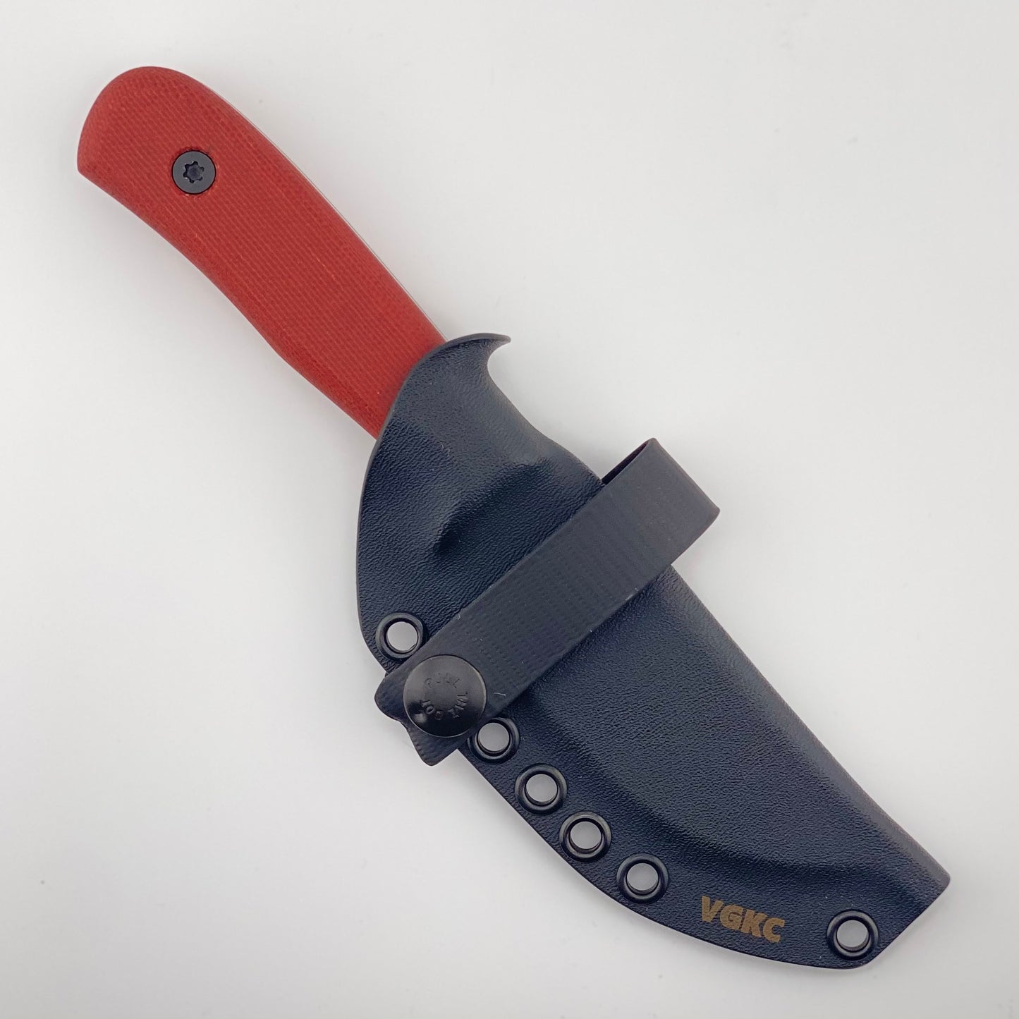 Knife with red handle in a black sheath on a white background