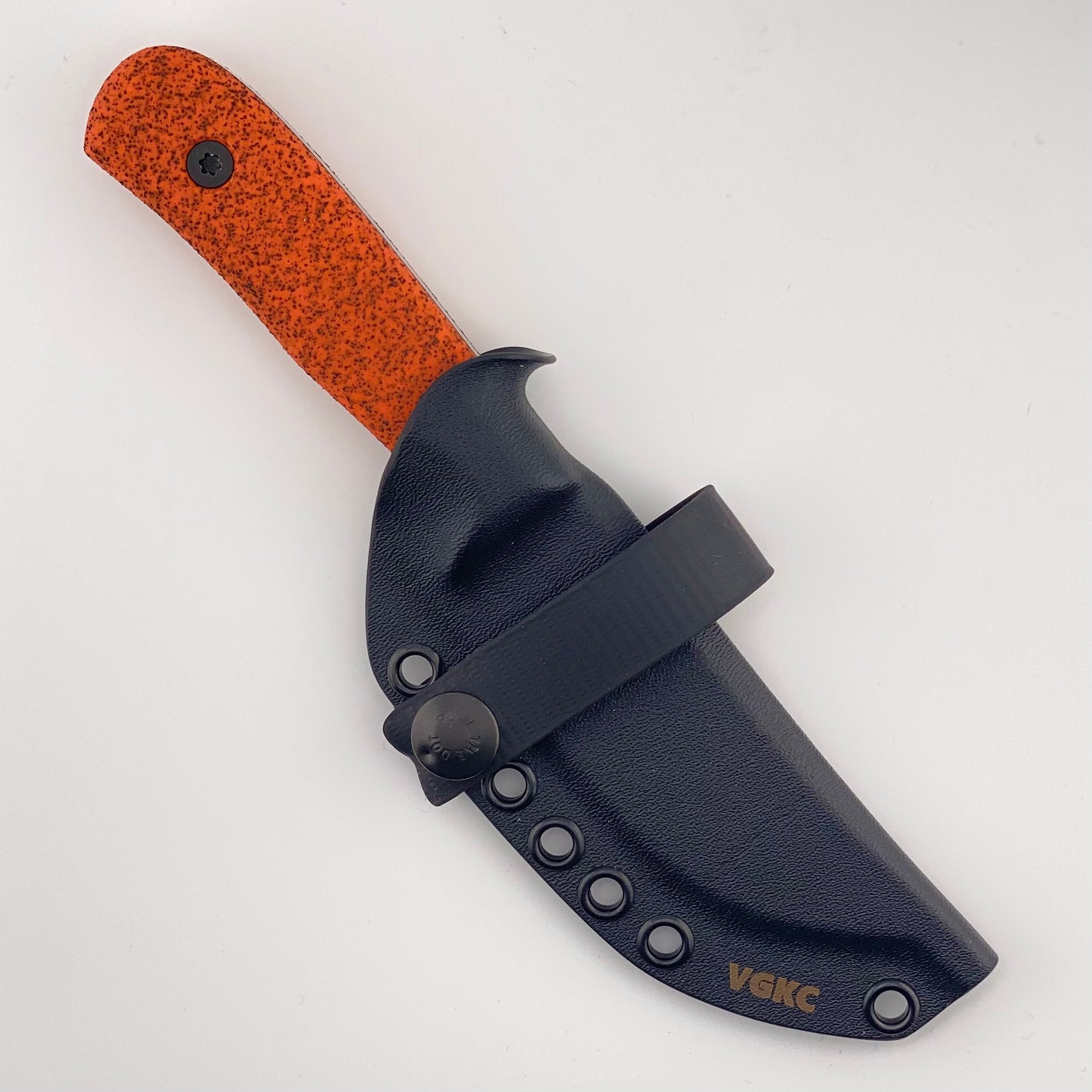 Orange handled knife in a black sheath on a white background