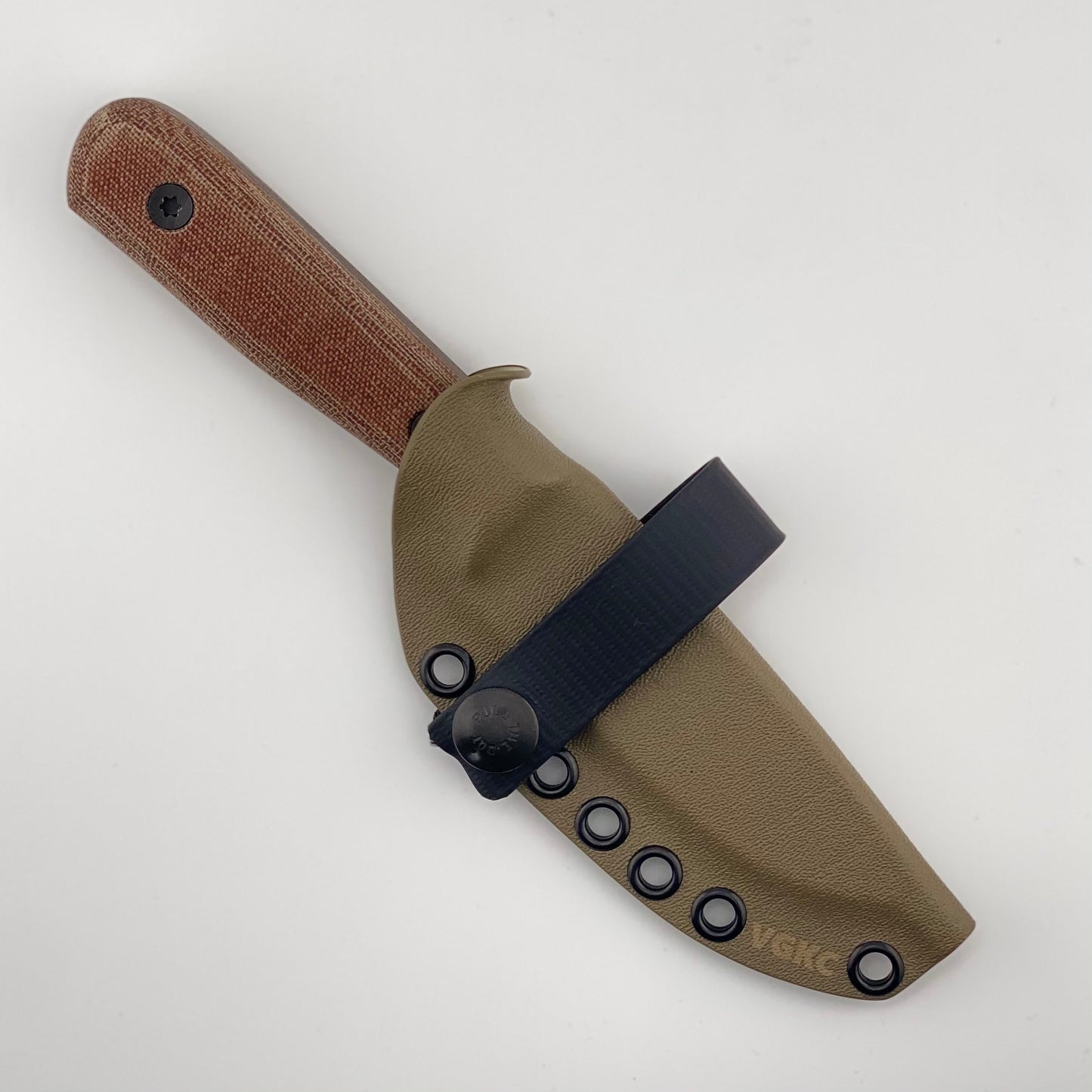Bronze fixed blade knife with brown handles in a tan sheath with a black strap on a white background