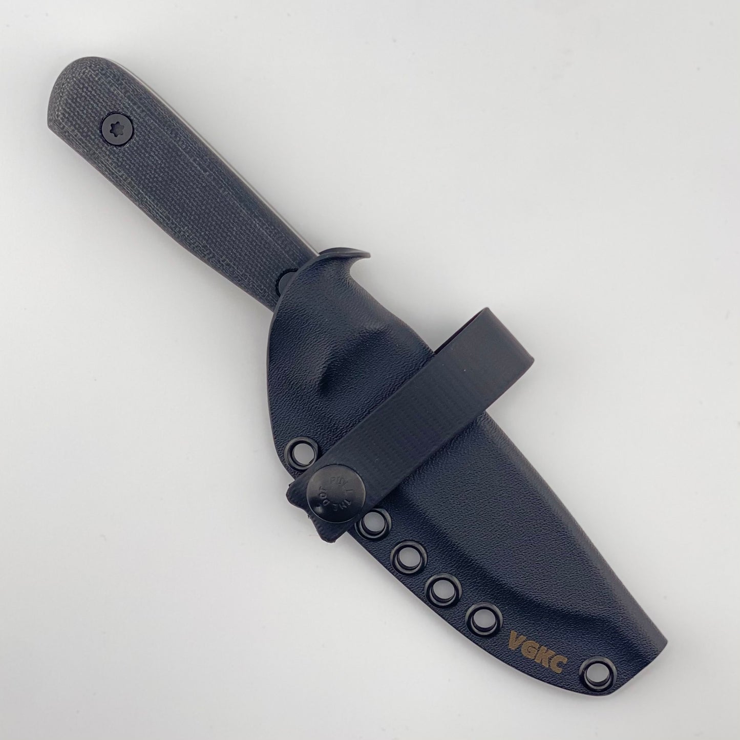 Fixed blade knife with black handles in a black sheath with a black strap on a white background