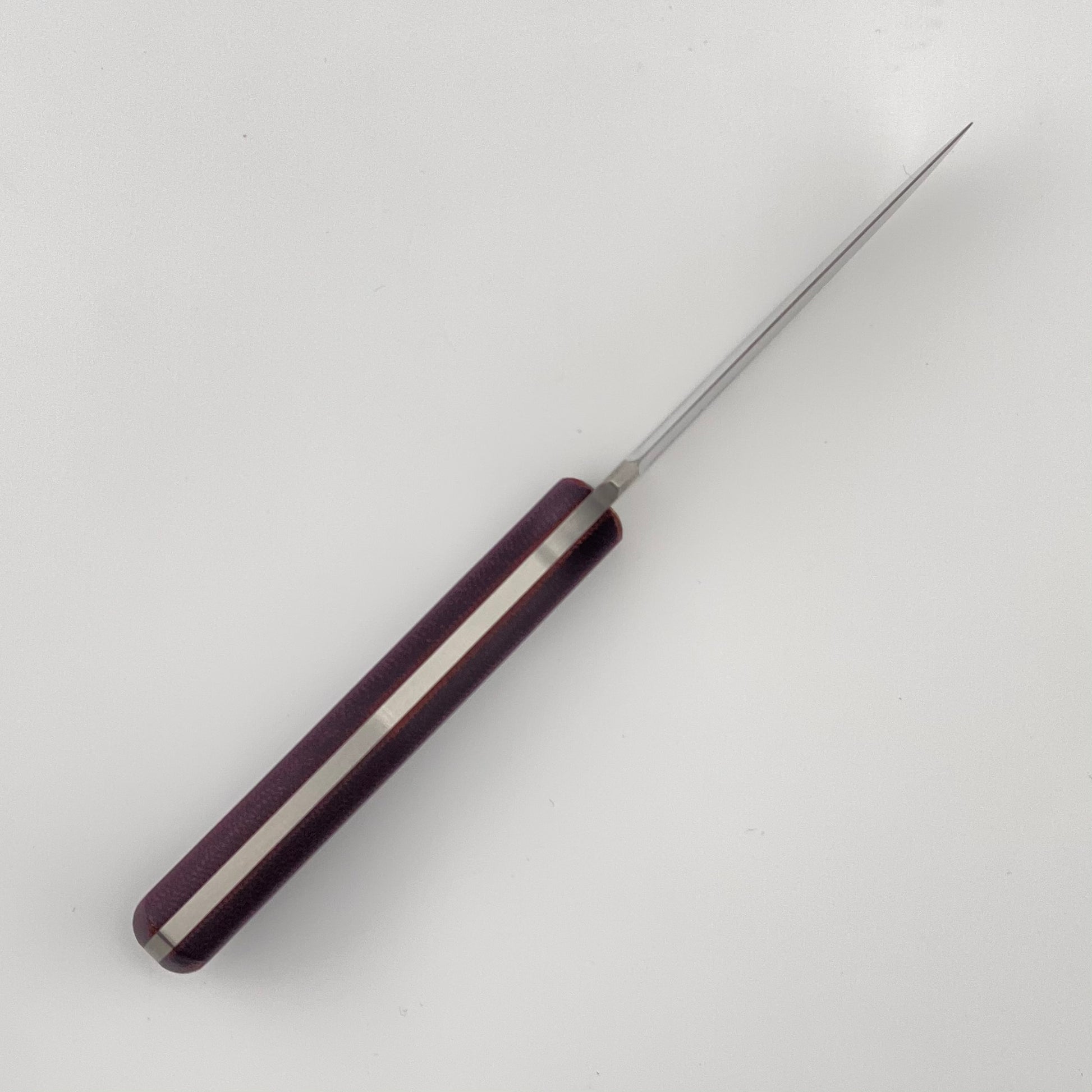 Knife with purple handle on a white background
