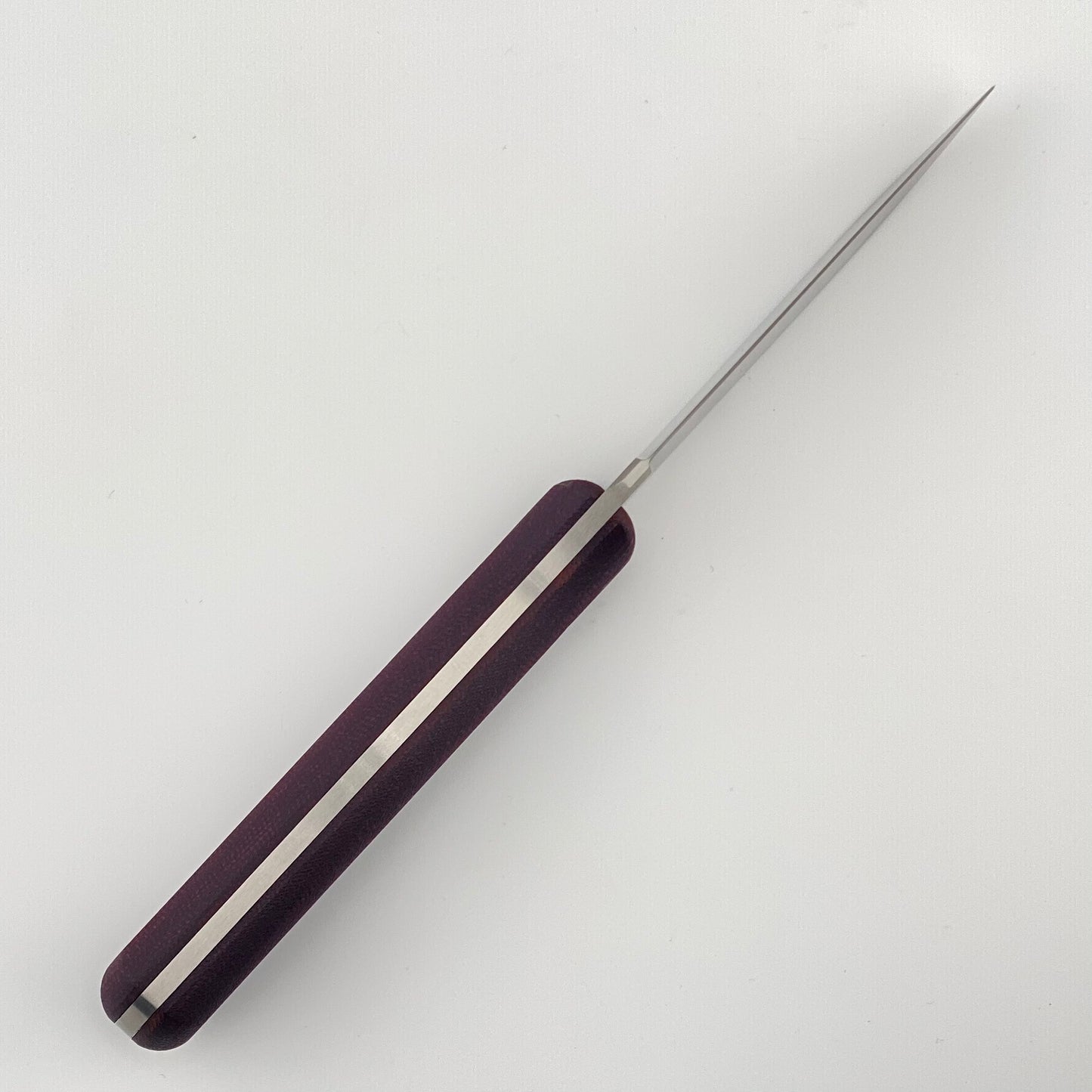Knife with purple handle on a white background