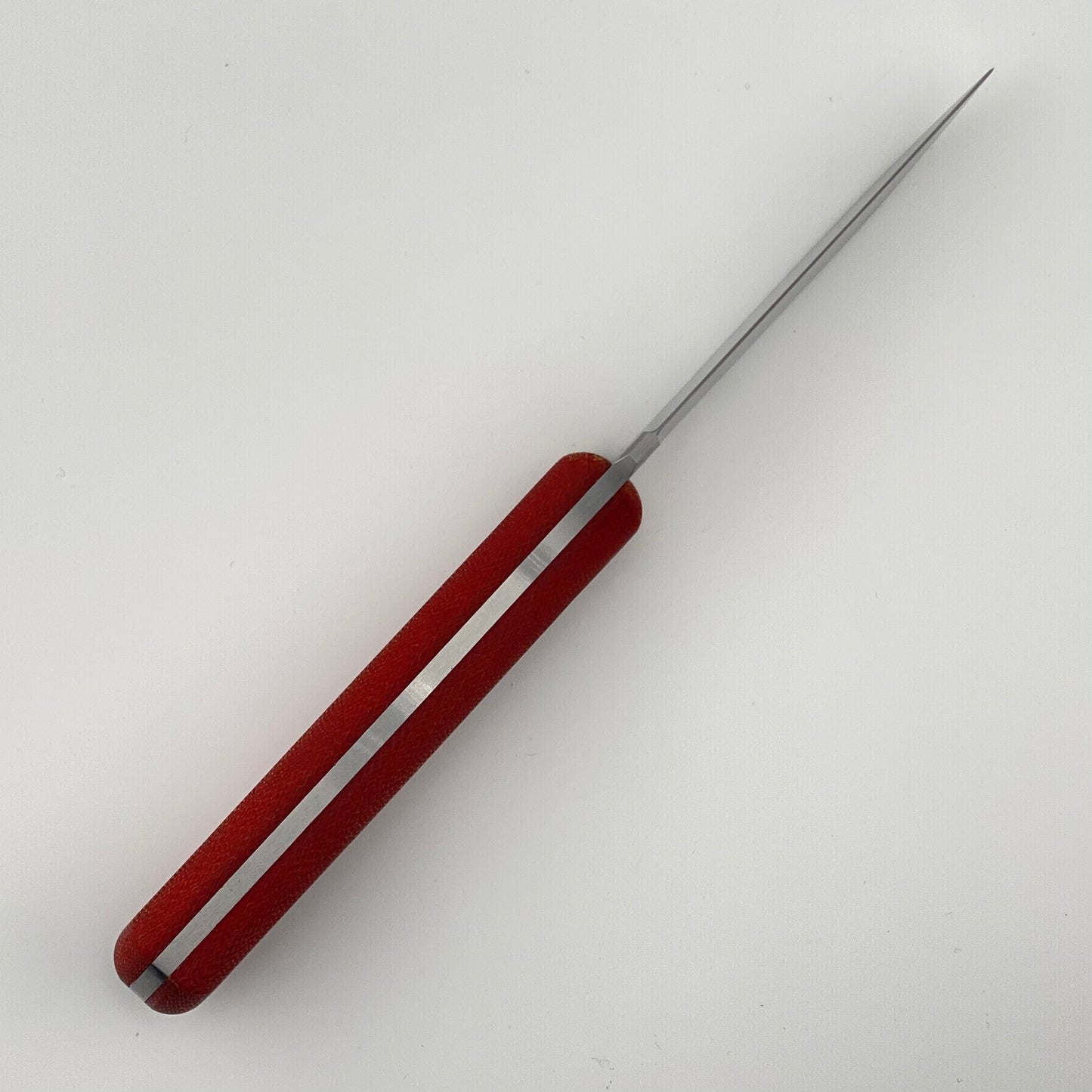 Red-handled knife on a white background