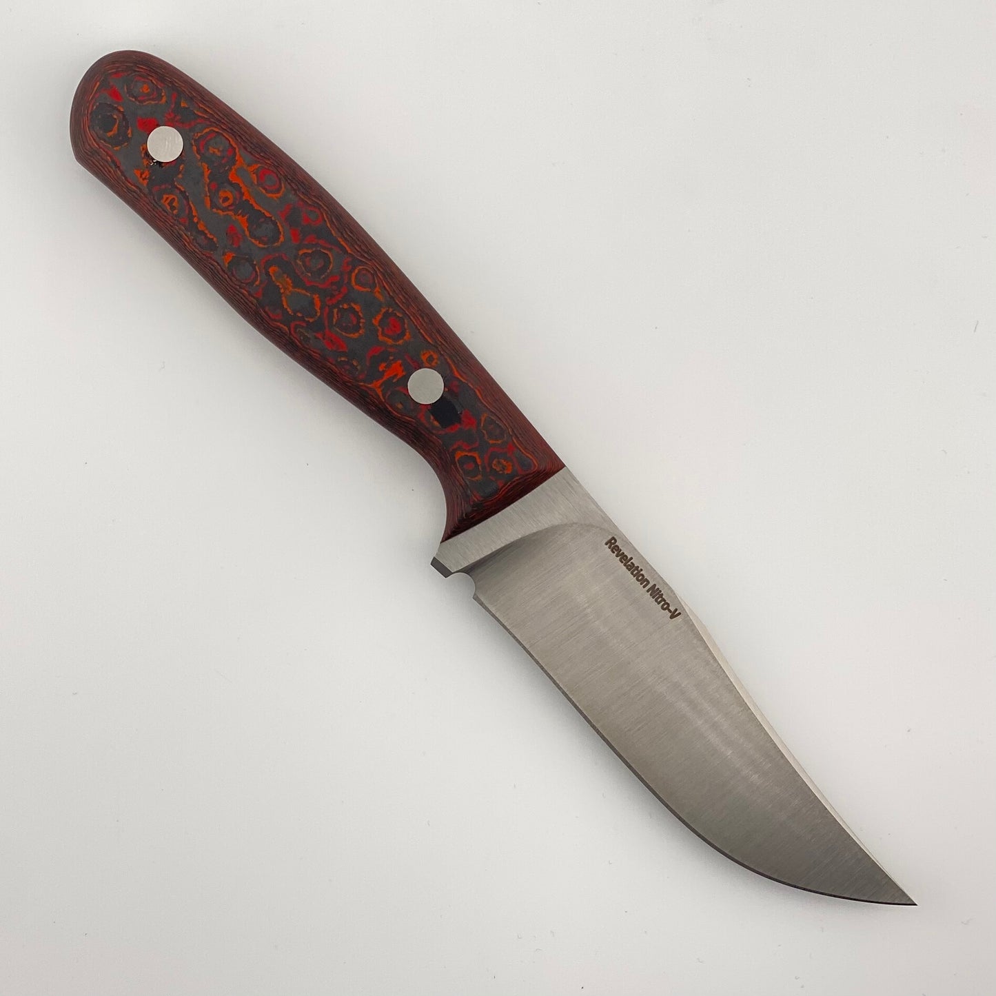 Fixed blade knife with red, orange, and black handle on a white background 
