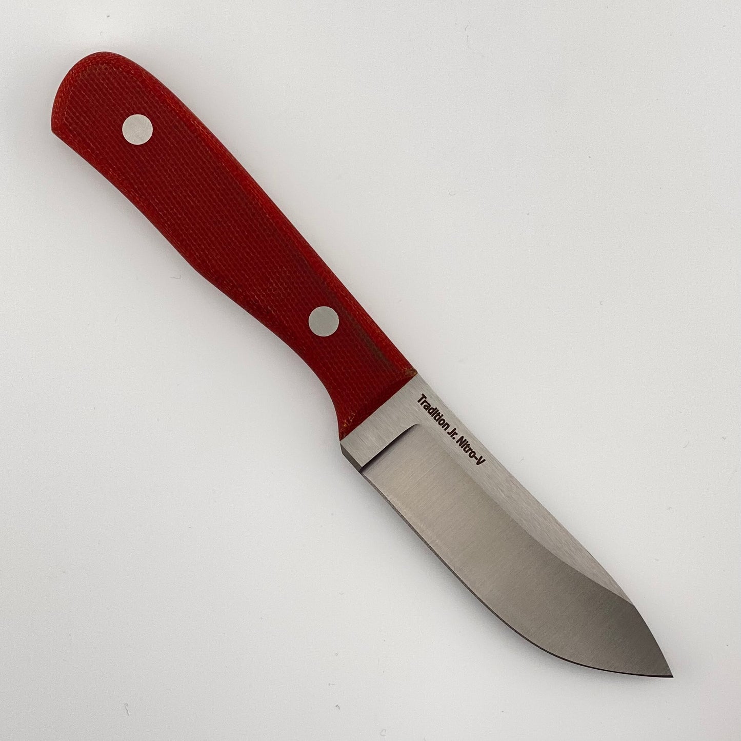 Fixed blade knife with red handles on a white background