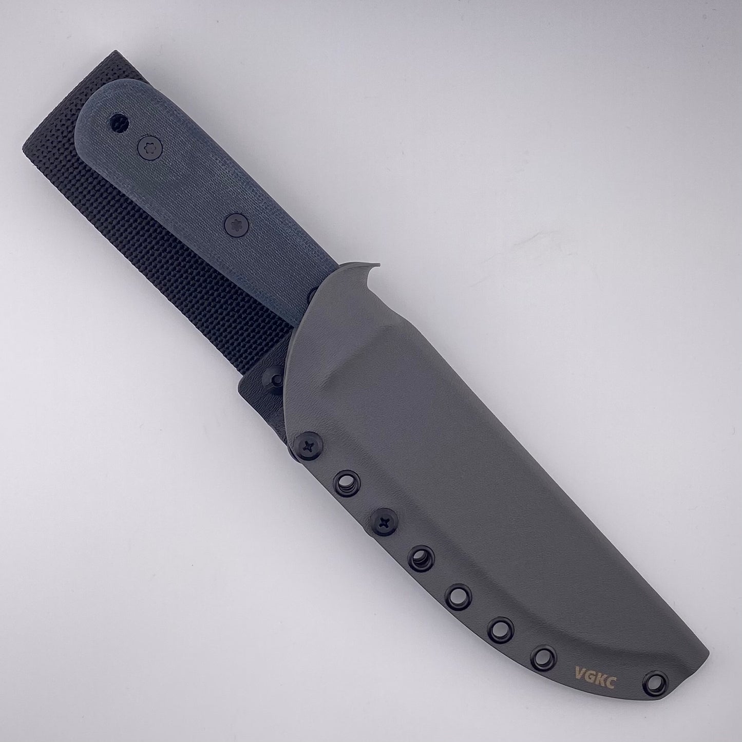 Fixed blade knife with denim blue handles in a gray sheath on a white background