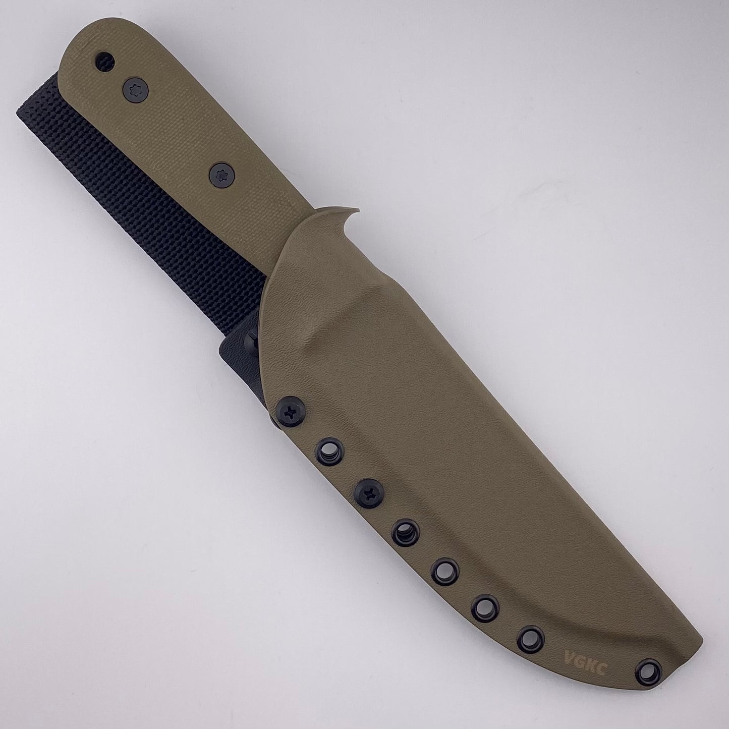 Fixed blade knife with green handles in a tan sheath on a white background