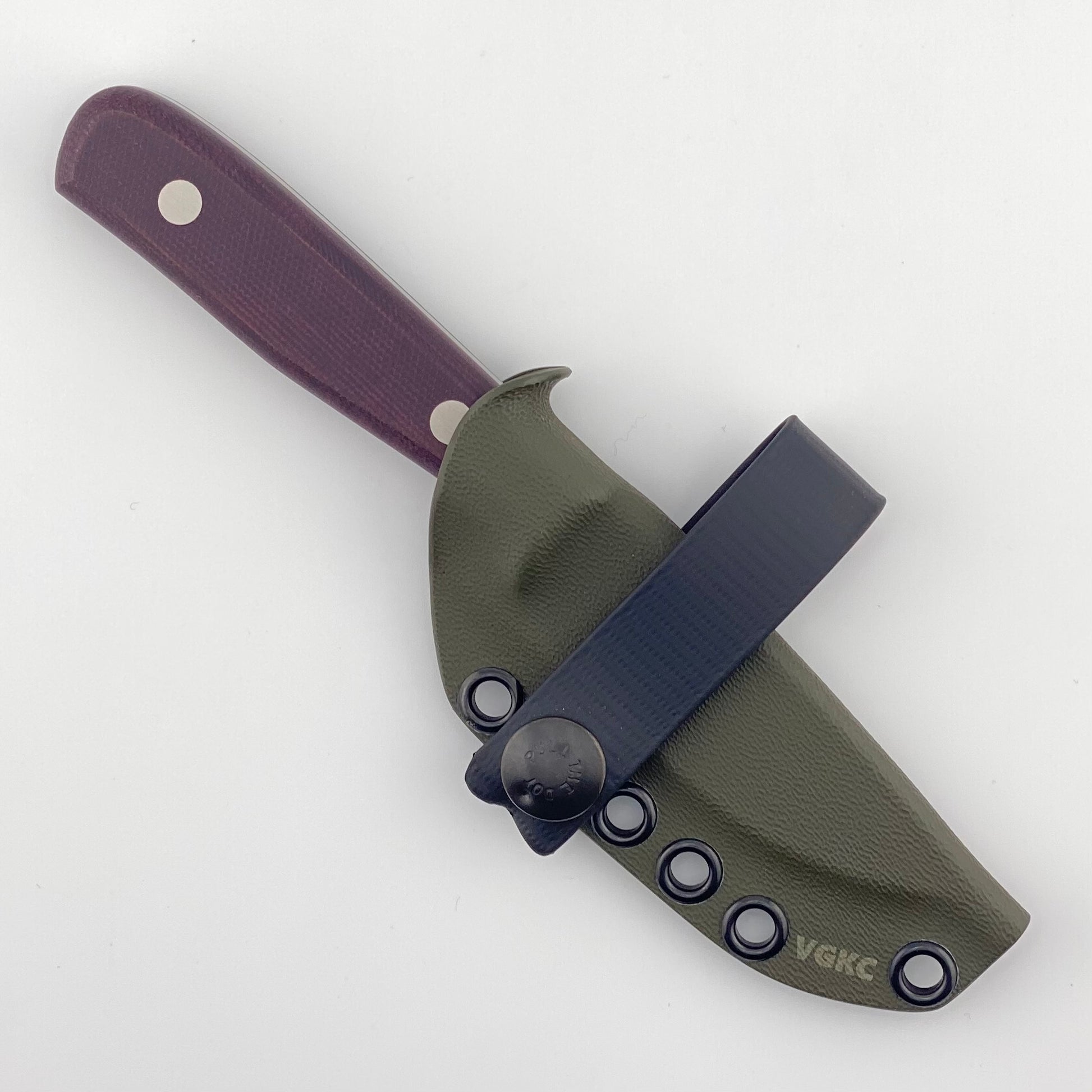 Fixed blade knife with burgundy handles in a dark green sheath on a white background