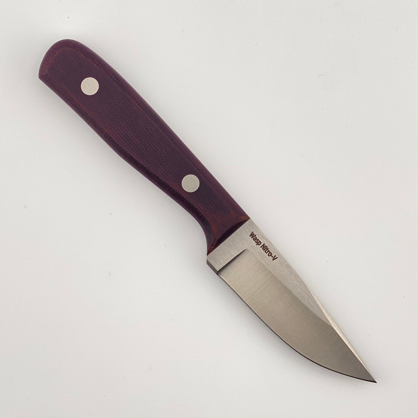 Fixed blade knife with purple handles on a white background